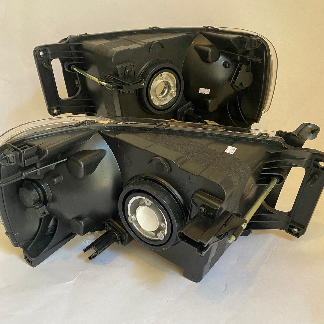02-05 DODGE RAM 1500 black housing pair of headlights