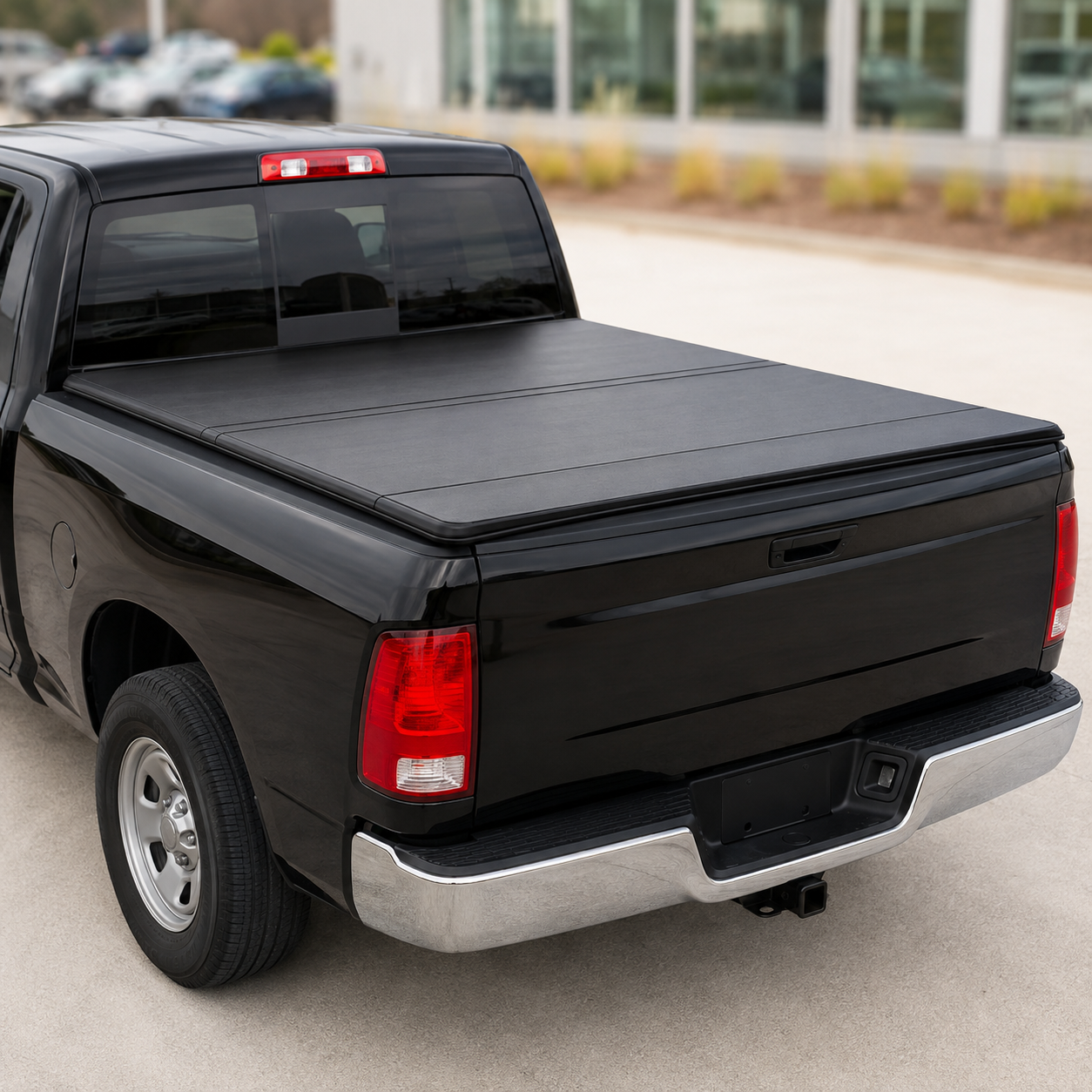 Black hard tri-fold tonneau cover on pickup truck