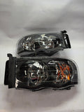 02-05 DODGE RAM 1500 black housing pair of headlights