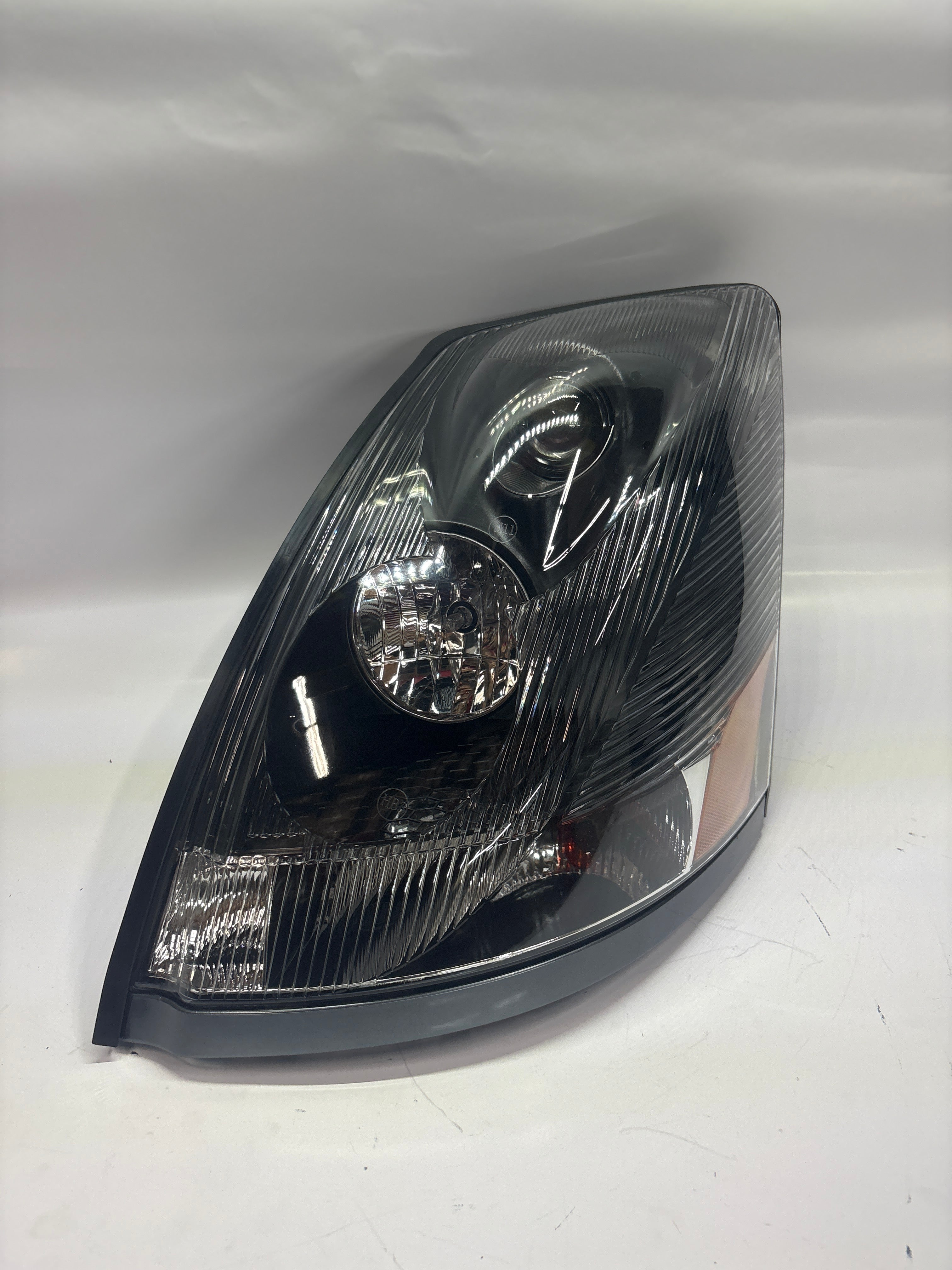 04-17 Volvo VNL Left Driver Side Black Amber Headlight