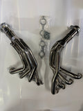 Set of polished metal exhaust pipes on a white background