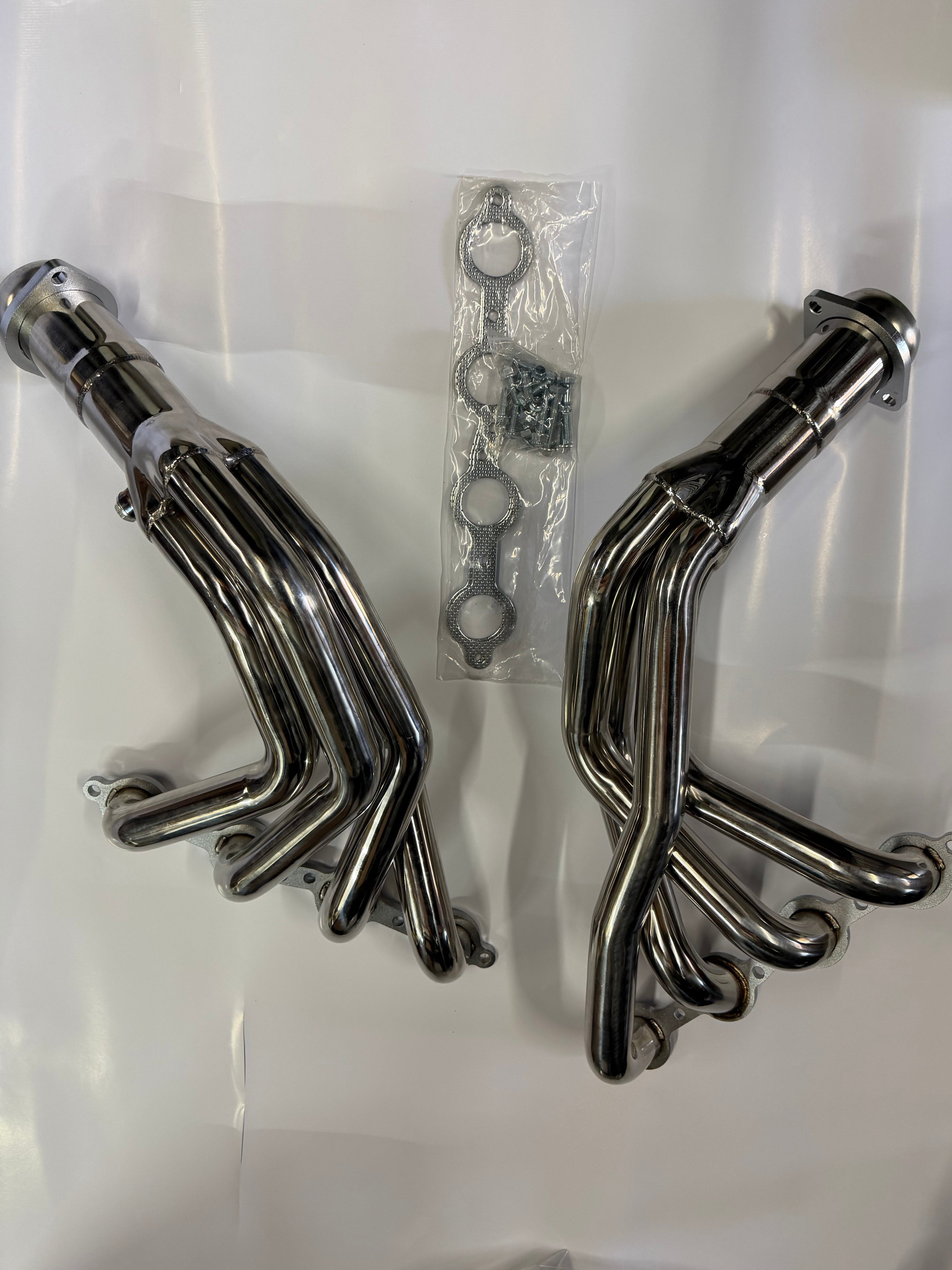 Set of polished metal exhaust pipes on a white background