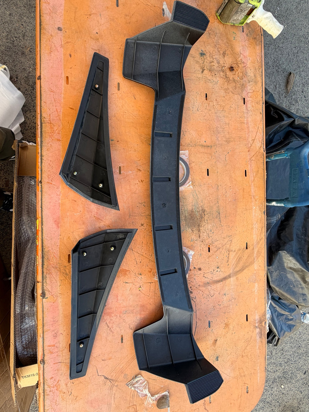 Actual three-piece roof spoiler kit underside and mounting screws