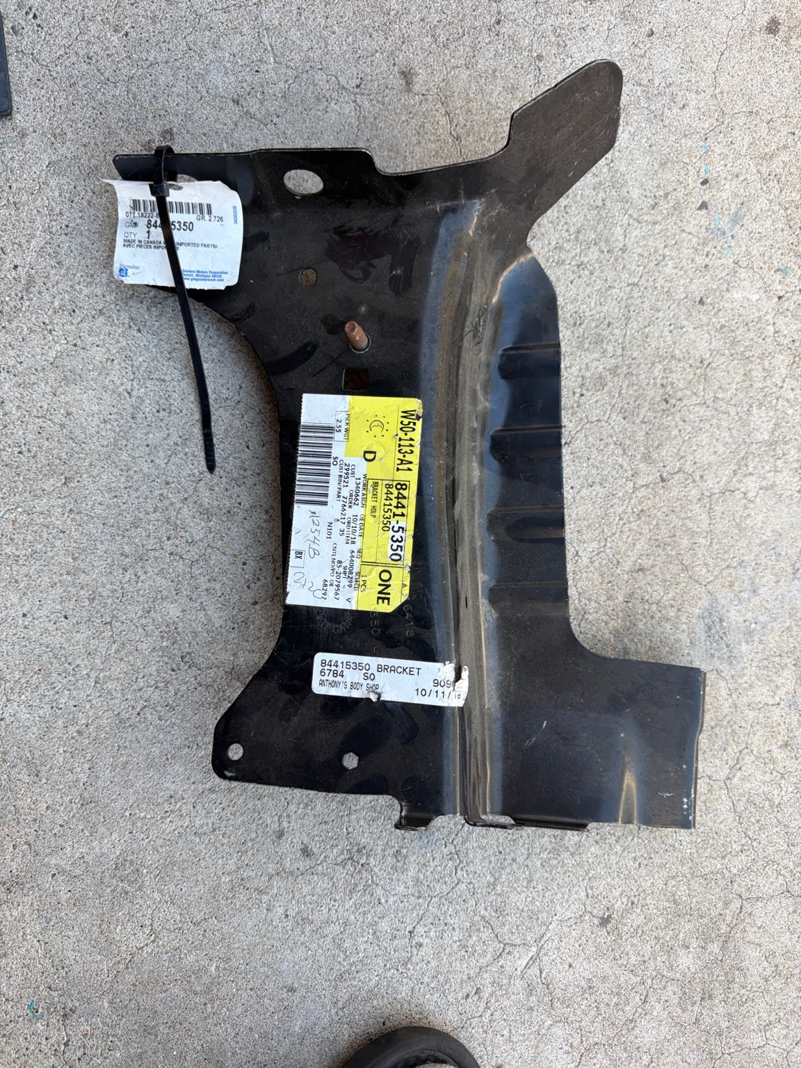 Actual GM 84415350 Headlamp Bracket Assembly in Tote 37A