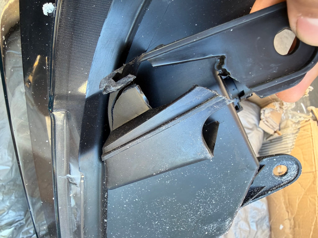 Right headlight broken mounting bracket detail