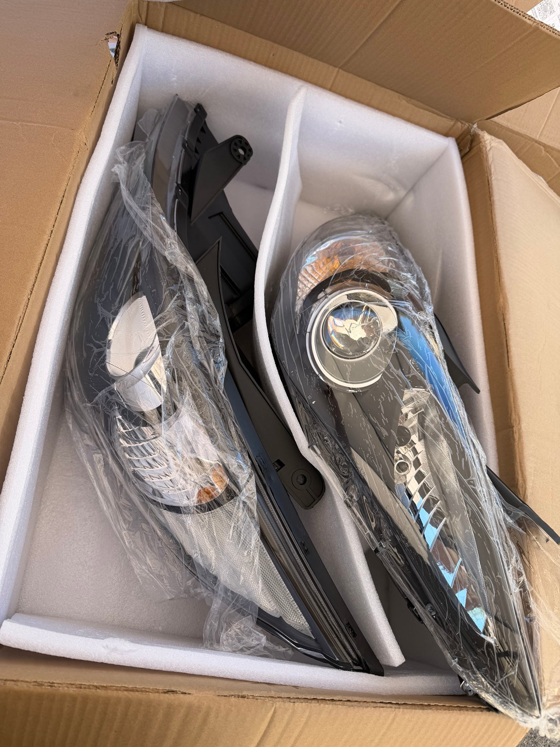 Actual HL-OH-HSON11-BK-CL1 headlight pair in protective packaging