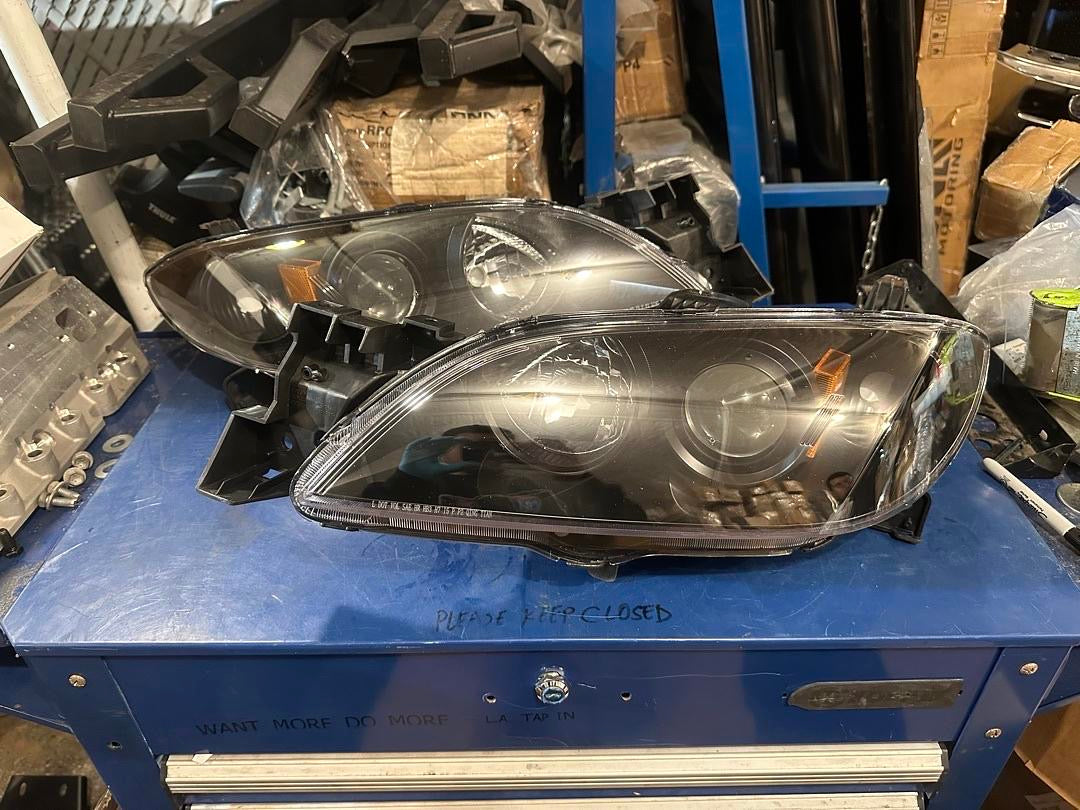 04-09 MAZDA 3 4DR BLACK HOUSING AND CLEAR PROJECTOR HEADLIGHTS