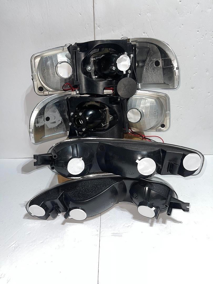 01-06 GMC DENALI BLACK HOUSING WITH CLEAR REFLECTOR HEADLIGHTS HALOGEN