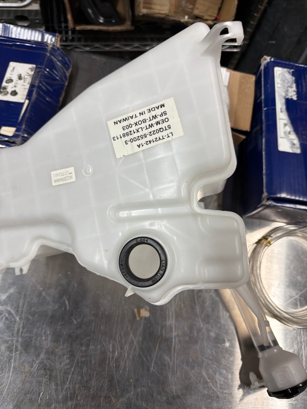 Actual returned Lexus washer reservoir showing OEM-WT-LX1288113 label