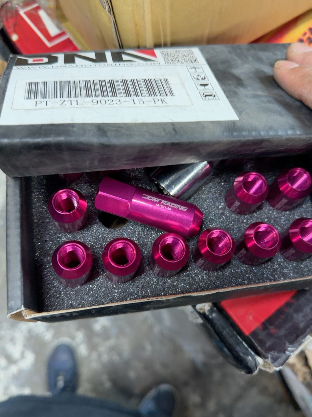 JDM Racing pink M12x1.5 lug nut kit photographed in box, SKU PT-ZTL-9023-15-PK