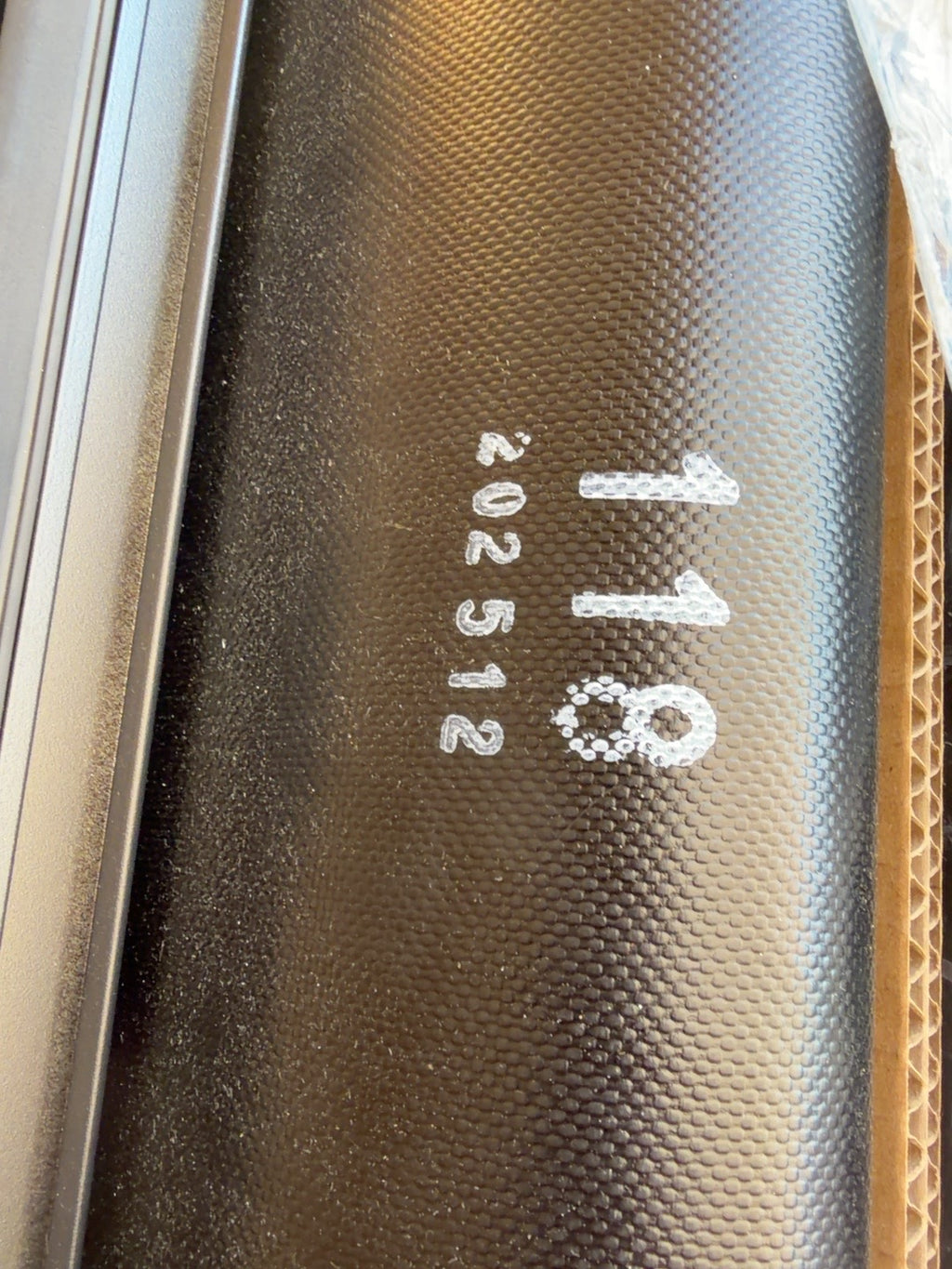 Actual black soft roll-up tonneau cover showing 118 marking