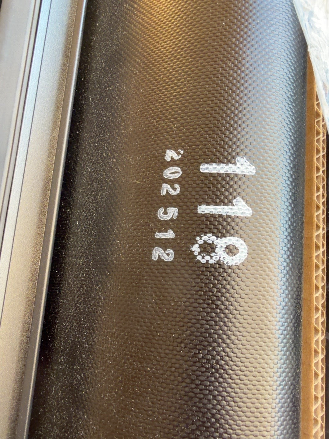 Actual black soft roll-up tonneau cover showing 118 marking