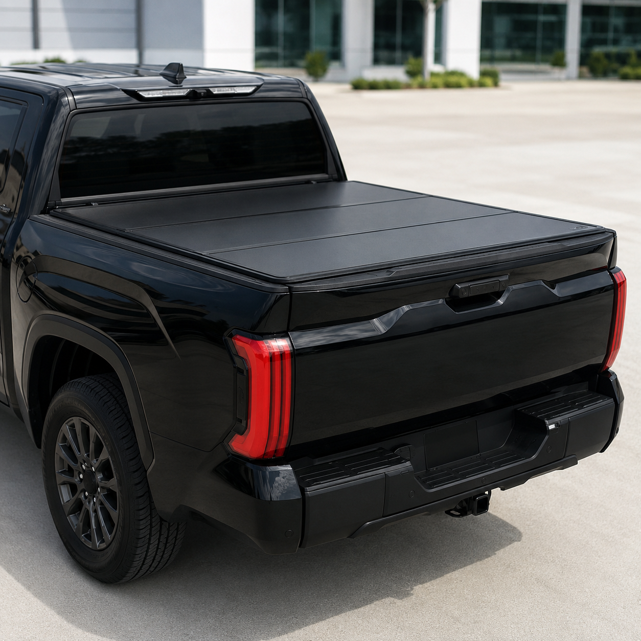 Black flush hard tri-fold cover on late-model pickup truck