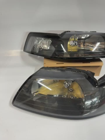AS IS 99-04 FORD MUSTANG BLACK HOUSING AND CLEAR WITH CLEAR HEADLIGHTS